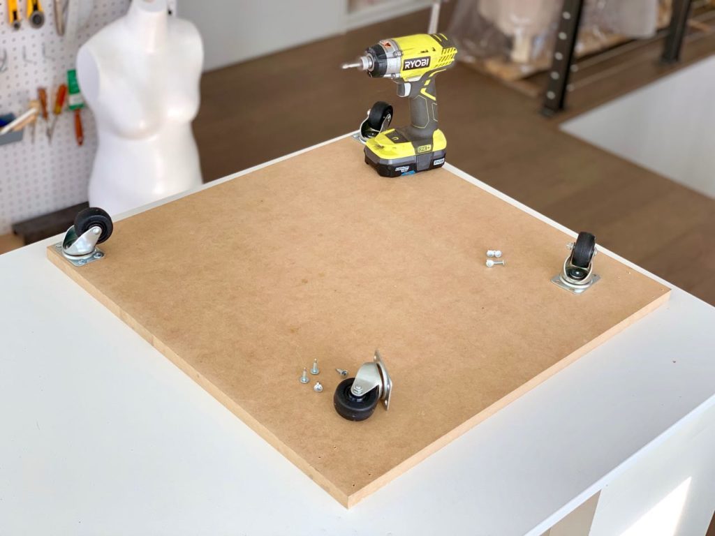 attach the wheels to the base of the caddy