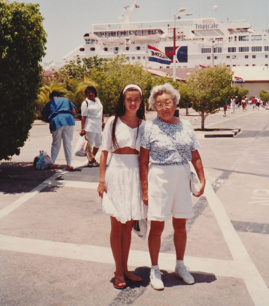 Teenage girl and her grandmother standing in front of a Carnival cruise ship